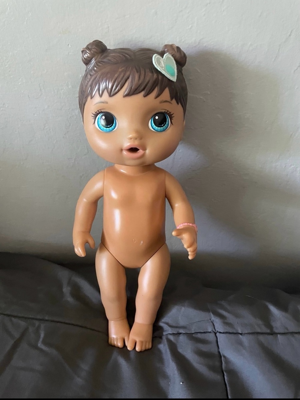 Hasbro Brown Skinned Baby Doll with Blue Eyes and Heart Hair Clip
